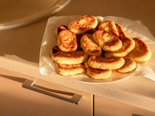 Freshly baked cottage cheese pancakes cooling on kitchen counter