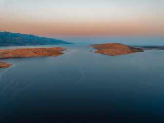 View of the Zrmanja River Canyon in Croatia, with winding turquoise waters cutting through limestone cliffs. A scenic natural wonder popular for kayaking and hiking