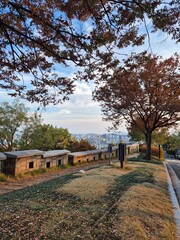 Seoul City View from Naksan Fortress Wall under Autumn Foliage, South Korea