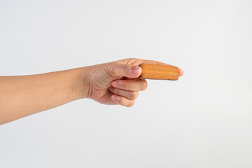 Chocolate bar in hand on white background