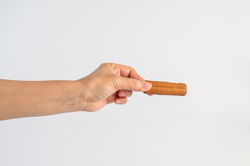 Chocolate bar in hand on white background