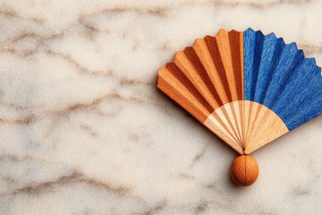 Small, decorative fan on marble