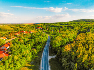 Naklejka premium Gant, Hungary, view of the terraces of an old bauxite mine and bauxite formation with red and orange surface. Gánt Bauxitbánya. aerial