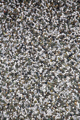 Close-up of textured pedestrian walkway surface made of small gravel.