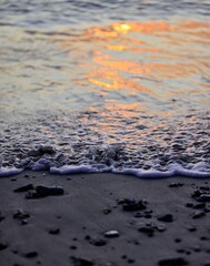 Sunset waves on rocky shoreline