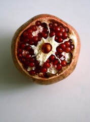 Close-up of a pomegranate with juicy red seeds. A nutritious fruit packed with vitamins, antioxidants, and iron. Supports hemoglobin levels and boosts overall health.