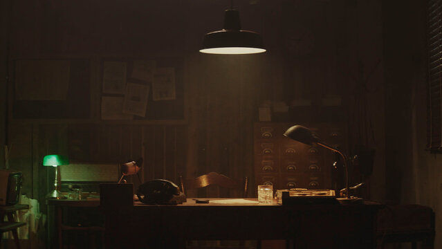 Vintage desk illuminating secrets in a moody detective's office
