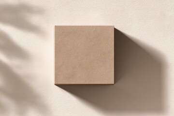 Beige square box on light beige surface,  shadowed