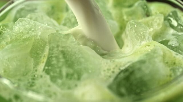 Super Slow Motion Detail Shot of Pouring Cream into Matcha Latte with Camera Motion at 1000fps.