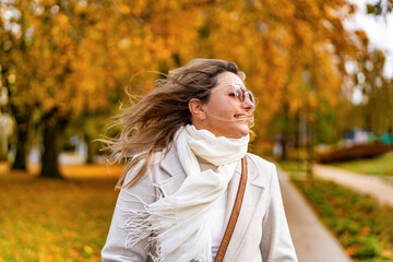 Portrait of beautiful mature woman in autumn scenery