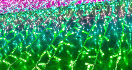 background of holiday colorful green garland for texture and design, festive decoration close up