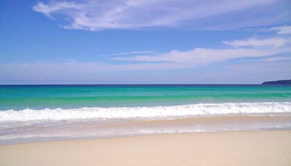 Fototapeta premium Serene turquoise ocean waves gently lap a pristine sandy beach under a bright blue sky.