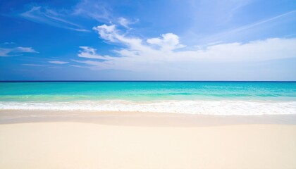 Serene tropical beach scene with turquoise water and white sand under a bright blue sky