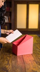 Obraz premium Woman opening unique gift box, indoors