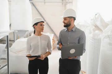 Engineers inspecting food production in factory
