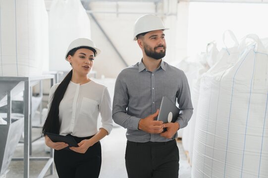 Engineers walking and discussing in factory