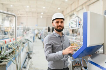 Engineer operating machinery on production line in modern factory