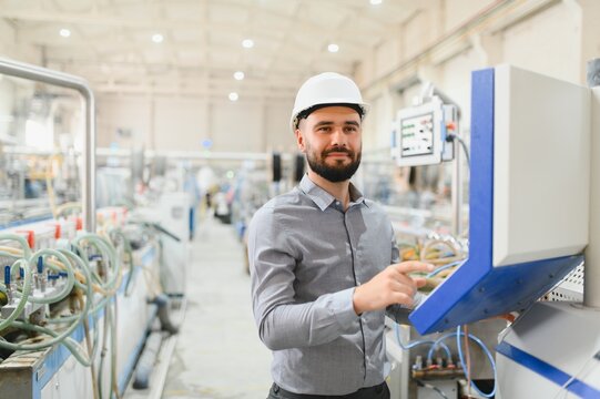 Engineer operating machinery on production line in modern factory
