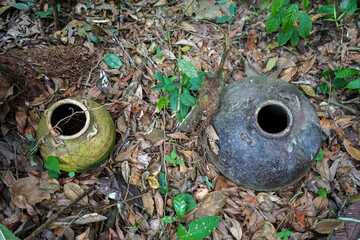 a close up of an old jar in the ground