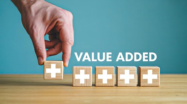 Hand arranging wooden blocks with plus icons showing value added business concept
