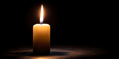 Single Candle Flame in Dark.