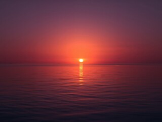 Crimson Sea. A Fiery Sunset over the Tranquil Waters of the Evening Calm.