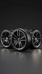 Dark, glossy car wheels set on dark background