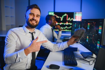 Holding Dollar bills in the stock market. Investor counting money after making it big on the stock market