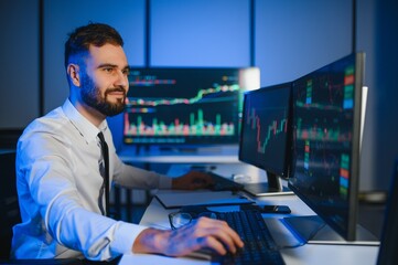 Crypto trader investor analyst looking at computer screen analyzing financial graph data on monitor
