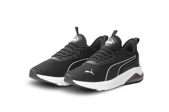 Pair of black Puma sneakers isolated on transparent background