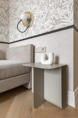 Modern Interior Detail with Beige Sofa, Wall Lamp and Designer Table