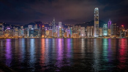 Obraz premium Hong Kong skyline at night, vibrant lights reflected