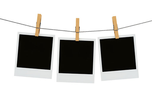 Fototapeta Instant photos on a string with clothespins, black picture frames, Isolated on transparent background.  