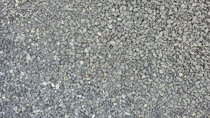 Gray gravel floor in the yard, parking lot with gravel on the ground, outdoor floor with small stones, gravel road, gravel texture image.