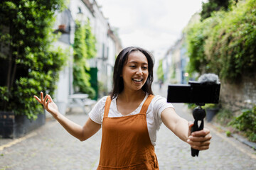 Vlogger recording content outdoors with smartphone and microphone