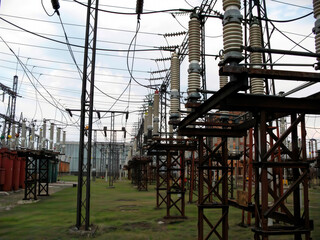 High voltage electrical substation 110 kV. A large power distribution station with many towers, ceramic insulators.