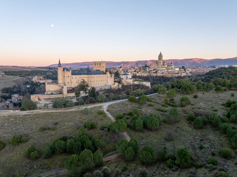 Aerial view of the Alc&Atilde;&iexcl;zar of Segovia and the Segovia Cathedral rise majestically against the soft dawn light, a symphony of stone and sky, Segovia, Castilla y Le&Atilde;&sup3;n, Spain.