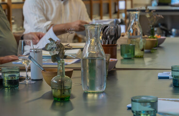 White wine glass at conference table, pair and writing utensils 2025