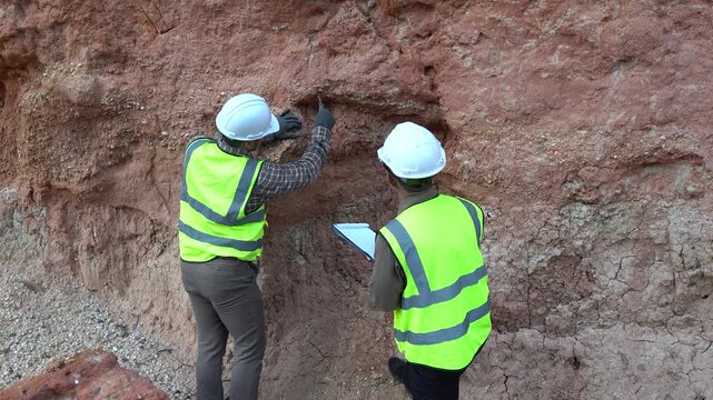 Geologist engineer working at mining site, excavating rock for analysis, checking soil minerals, identifying metals like gold, studying rock layers, and inspecting contamination for environmental safe