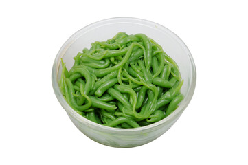 Close-up of traditional Thai dessert ingredient lod chong, green pandan rice flour noodles served in a clear glass bowl