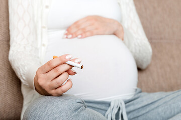 Pregnant woman with cigarette at home. mother smoking concept