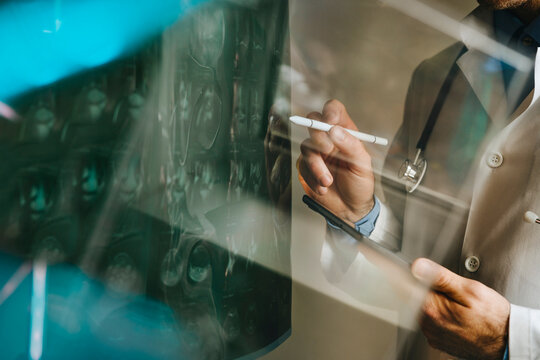 Doctor examining x-ray using digital tablet and medical technology