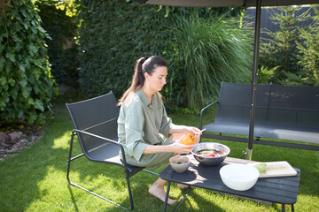 Woman cooking in her backyard