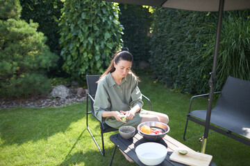 Woman cooking in her backyard