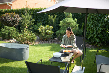 Woman cooking in her backyard