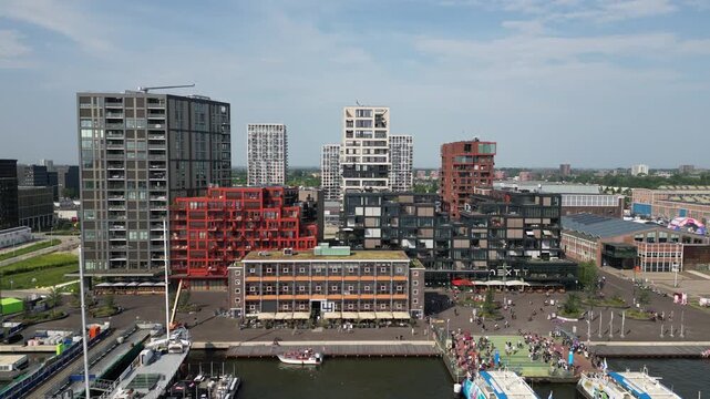 Drone view of NDSM in Amsterdam. Modern architecture, creative hub, and waterfront with cultural spaces. Aerial panorama of a trendy urban district in the Netherlands.