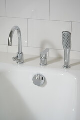 Modern bathroom sink with chrome faucet and shower head