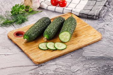 Raw green cucumbers with slices