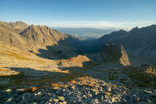 Aerial view of sunlight kissing the rugged peaks and valleys of the High Tatras, casting long shadows across the landscape, Vysok&Atilde;&copy; Tatry, Pre&Aring;&iexcl;ovsk&Atilde;&frac12; kraj, Slovakia.