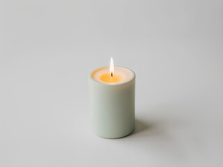 Minimalist candle with soft warm glow on white background